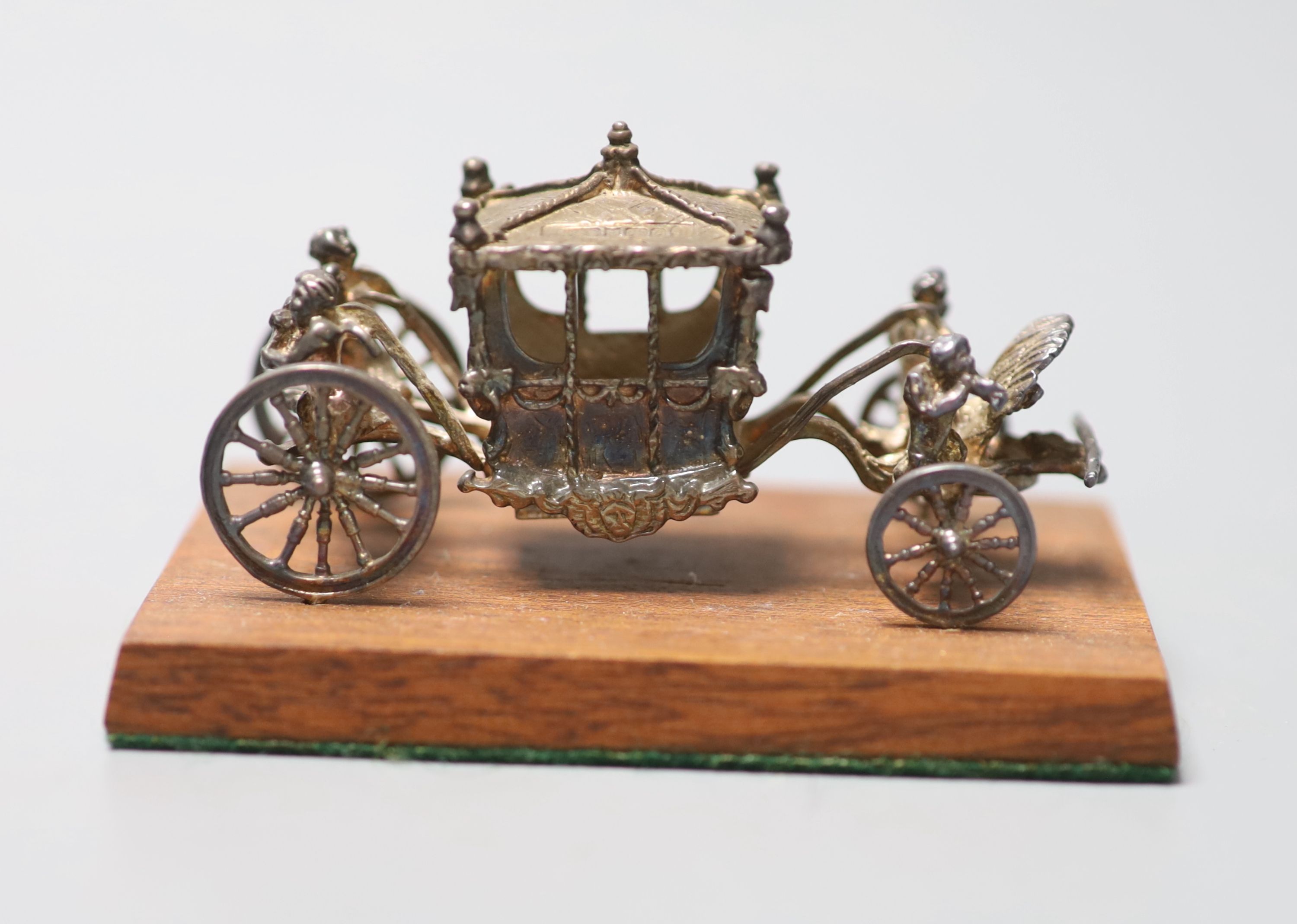 A 1970s miniature silver model of the Coronation coach, London, 1977, 75mm, fixed on a wooden base, in box.